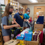 volunteers pack backpacks